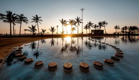 Sun setting over the water of a  swimming pool at a luxury leisure accommodation 